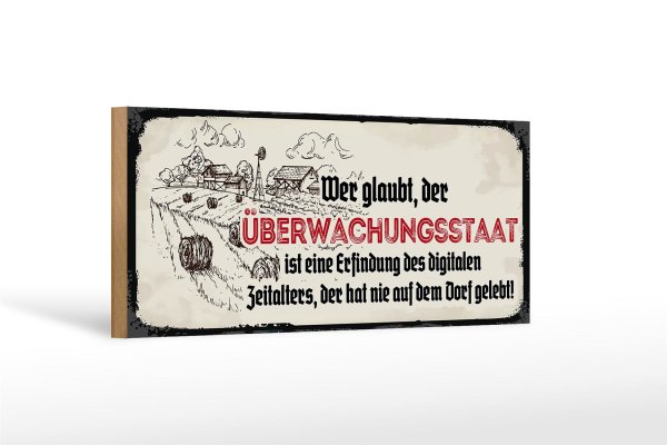 Holzschild Spruch 27x10cm Überwachungsstaat Dorf