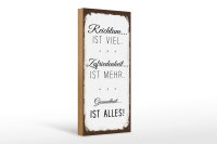 Holzschild Spruch Reichtum viel Zufriedenheit mehr 10x27cm